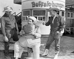 Radio DJ Texas Tiny eats buffalo burger, Buffalo Ranch, Newport Beach, Mar. 1955