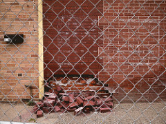 Fallen bricks and faded flag