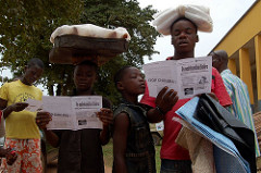Children read cholera-prevention leaflets