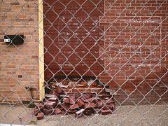 Fallen bricks and faded flag