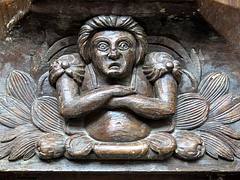 An angry woman: 16th C. misericord, the Collegiate Church of Notre-Dame (Collégiale Notre-Dame), Le Puy-Notre-Dame, Anjou, France