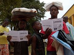 Children read cholera-prevention leaflets