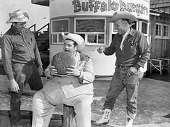 Radio DJ Texas Tiny eats buffalo burger, Buffalo Ranch, Newport Beach, Mar. 1955